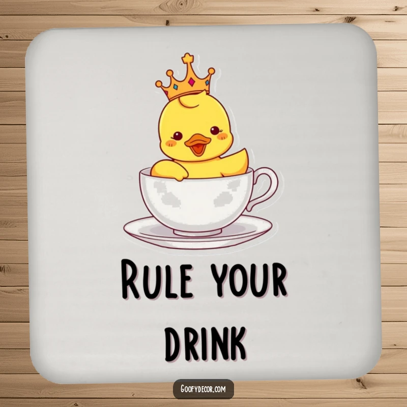 Funny coaster with a crowned rubber ducky sailing in a teacup, protecting surfaces with royal charm and playful design.