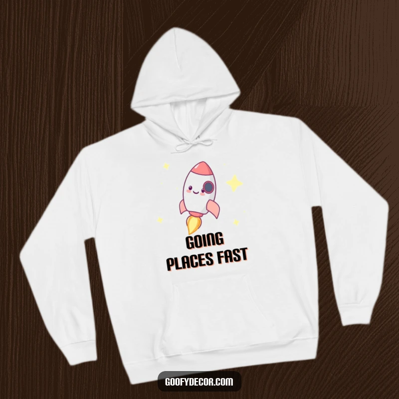 Funny hoodie showing a tiny, happy rocket character zooming dynamically through a vibrant, starry galaxy backdrop.
