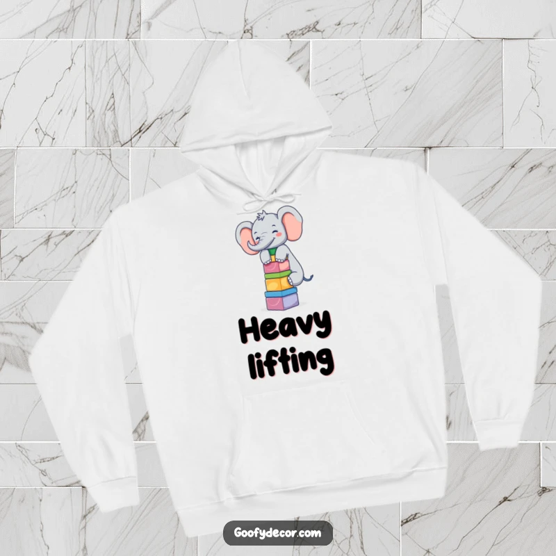 Funny giggling elephant balancing blocks on its trunk, featured on a warm and humorous hoodie.