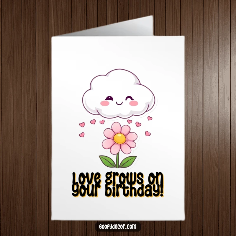 Funny Free Printable Birthday Card: Smiling cloud playfully raining small hearts onto a cheerful, happy flower below.