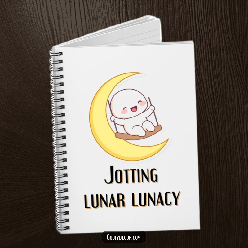 Funny laughing moon character swinging on a crescent moon, featured on a notebook cover for celestial journaling.